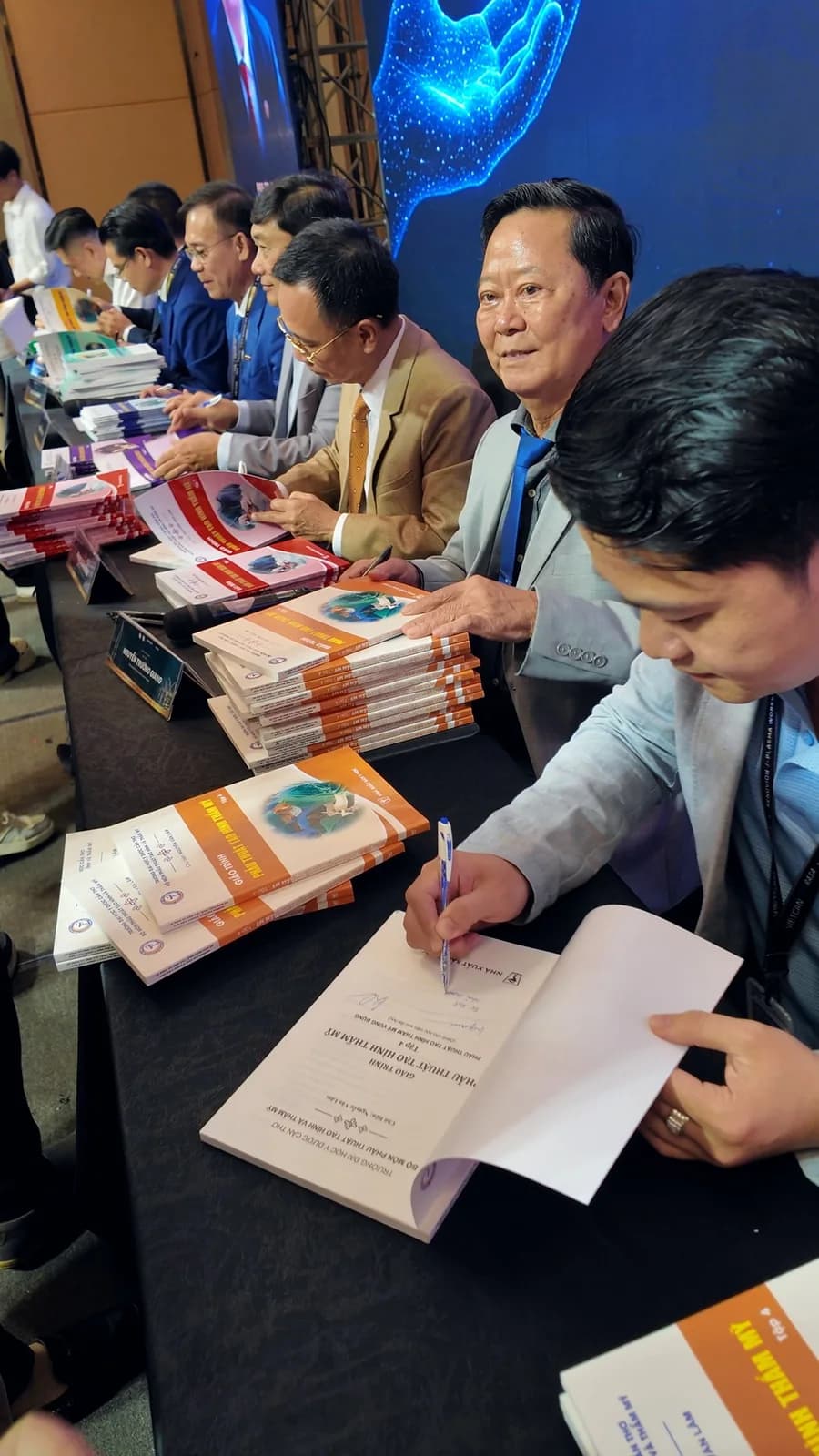 The signing table with the textbook volumes