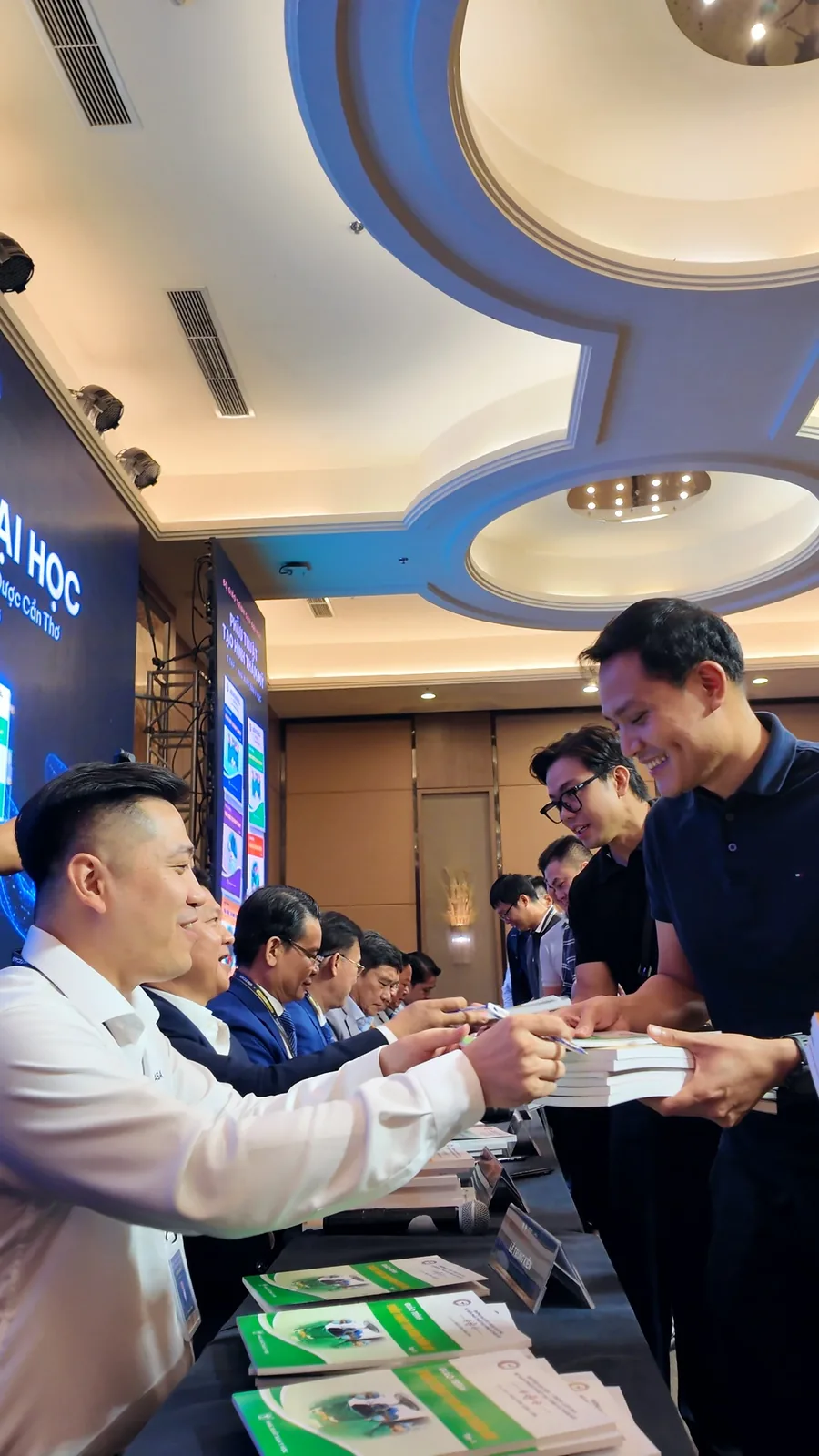 A delegate receiving a copy from Dr. Kien