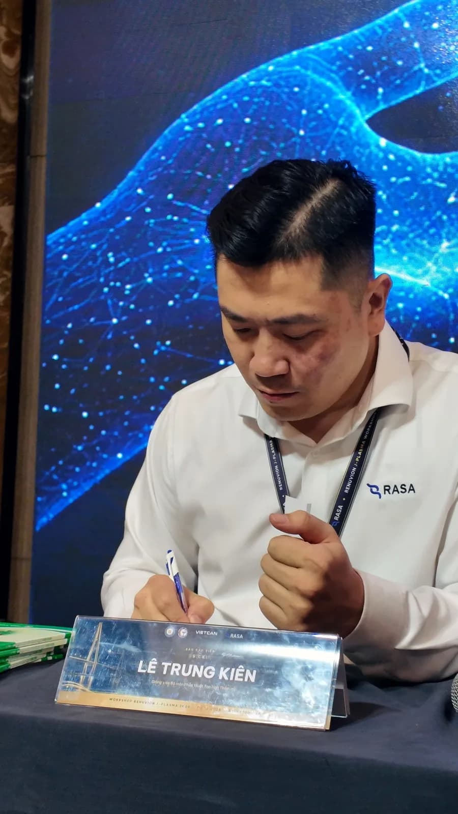 Dr. Le Trung Kien signing textbooks at the launch